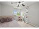 Bright bedroom featuring a comfortable bed, a window view, stylish decor, carpeted floors and ample natural light at 2667 E 132Nd Ave, Thornton, CO 80241