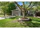 Beautiful home showcasing a mature tree in a landscaped front yard and cozy porch at 2667 E 132Nd Ave, Thornton, CO 80241