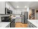 Modern kitchen featuring stainless steel appliances, gray cabinetry and granite counters at 2667 E 132Nd Ave, Thornton, CO 80241