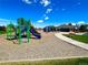 Community playground area featuring slides, and other play equipment surrounded by wood chip ground cover at 2667 E 132Nd Ave, Thornton, CO 80241