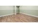 Basement features hardwood floors with green walls and white trim at 4006 S Atchison Way, Aurora, CO 80014