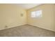 Bedroom with yellow walls, carpeted floor, and a window that lets in natural light at 4006 S Atchison Way, Aurora, CO 80014