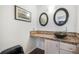Powder bathroom featuring a vessel sink, granite countertop, and decorative mirrors at 1240 Lone Scout Lookout, Monument, CO 80132
