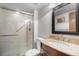 Bathroom featuring glass shower doors and vanity with granite countertops at 1240 Lone Scout Lookout, Monument, CO 80132