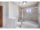 The bathroom features a glass enclosed shower over tub and tiled walls at 1240 Lone Scout Lookout, Monument, CO 80132