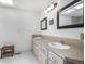 Bathroom featuring double sink vanity and tile floor and countertops at 1240 Lone Scout Lookout, Monument, CO 80132