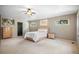 A spacious bedroom features neutral walls, a ceiling fan, carpeted floor and multiple windows at 1240 Lone Scout Lookout, Monument, CO 80132