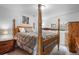 Comfortable bedroom with a four-poster bed, wooden furniture, and warm lighting at 1240 Lone Scout Lookout, Monument, CO 80132