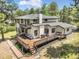 Spacious home exterior with an expansive deck and lush green surroundings at 1240 Lone Scout Lookout, Monument, CO 80132