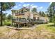 Beautiful home exterior with a multi-level deck overlooking manicured landscaping at 1240 Lone Scout Lookout, Monument, CO 80132