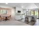 Bright kitchen featuring white cabinets, marble countertops, stainless steel appliances, and an adjacent breakfast nook at 1240 Lone Scout Lookout, Monument, CO 80132