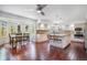 Open kitchen with stainless appliances, island with seating and an adjacent dining area with windows at 1240 Lone Scout Lookout, Monument, CO 80132