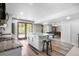 Open-concept kitchen with marble countertops, white cabinets, a central island, and access to the backyard at 1240 Lone Scout Lookout, Monument, CO 80132