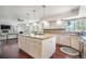 A spacious kitchen featuring white cabinets, an island cooktop, and modern stainless appliances at 1240 Lone Scout Lookout, Monument, CO 80132