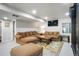 Cozy living room with a comfortable sectional, large tv, and plush seating at 1240 Lone Scout Lookout, Monument, CO 80132