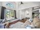 Bright living room features high ceilings, lots of natural light, and hardwood flooring at 1240 Lone Scout Lookout, Monument, CO 80132