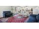 Cozy living room with comfortable seating, a patterned rug, and access to the kitchen at 1240 Lone Scout Lookout, Monument, CO 80132