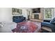 Living room featuring a stone fireplace, large rug, and comfortable seating at 1240 Lone Scout Lookout, Monument, CO 80132