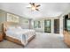 The bright main bedroom includes a ceiling fan, access to a private balcony, and lots of natural light at 1240 Lone Scout Lookout, Monument, CO 80132