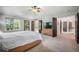 A spacious main bedroom allows access to a balcony, bathroom, and hallway at 1240 Lone Scout Lookout, Monument, CO 80132