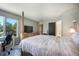 Spacious main bedroom with a large window, desk, and four-poster bed at 1240 Lone Scout Lookout, Monument, CO 80132