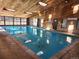 Well-maintained indoor swimming pool area featuring a wood paneled ceiling and a pool house at 519 Wright St # 304, Lakewood, CO 80228