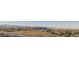 Expansive neighborhood view showcasing trees and distant mountains under a clear sky at 519 Wright St # 304, Lakewood, CO 80228