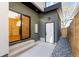 A modern patio with concrete pavers, a sliding glass door, a white door and river rock at 1737 Lowell Blvd, Denver, CO 80204
