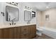 Modern bathroom with double vanity, sleek black fixtures, and tiled shower/tub at 1737 Lowell Blvd, Denver, CO 80204