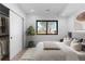 A modern bedroom with a large window, closet, and a plant in a pot at 1737 Lowell Blvd, Denver, CO 80204