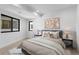 A nicely staged bedroom with neutral colors, a large window, and carpeted floors at 1737 Lowell Blvd, Denver, CO 80204