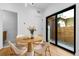 Bright dining area with a round wooden table, comfortable seating, and access to the outdoor area at 1737 Lowell Blvd, Denver, CO 80204