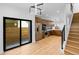 Open-concept living space with a modern kitchen, hardwood floors, and sliding doors to a private patio at 1737 Lowell Blvd, Denver, CO 80204