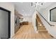 Spacious interior showcasing a modern kitchen, hardwood floors, and a staircase with black accents at 1737 Lowell Blvd, Denver, CO 80204