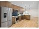 Modern kitchen featuring stainless steel appliances, stylish backsplash, and wood-tone cabinetry at 1737 Lowell Blvd, Denver, CO 80204