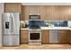 Contemporary kitchen with stainless steel appliances, subway tile backsplash, and sleek wood cabinets at 1737 Lowell Blvd, Denver, CO 80204