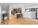 Open-concept kitchen with hardwood flooring, stainless steel appliances, and sleek countertops at 1737 Lowell Blvd, Denver, CO 80204