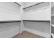A walk-in closet with shelving, carpet, and black bars to hang clothes at 1737 Lowell Blvd, Denver, CO 80204