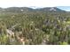 Aerial view of the community and surrounding mountains and forest at 12346 Bear Haven Rd, Conifer, CO 80433