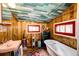 Retro bathroom features a wooden ceiling and vintage fixtures at 12346 Bear Haven Rd, Conifer, CO 80433
