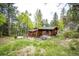 Cozy cabin with rustic details and outdoor seating area, perfect for enjoying the natural surroundings at 12346 Bear Haven Rd, Conifer, CO 80433