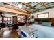 Living room with colorful wood ceiling and stone fireplace at 12346 Bear Haven Rd, Conifer, CO 80433