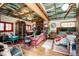 Unique living room featuring colorful décor, a stone fireplace, and hardwood floors at 12346 Bear Haven Rd, Conifer, CO 80433