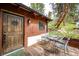 Inviting porch with outdoor seating and a beautifully crafted wooden door, perfect for relaxing at 12346 Bear Haven Rd, Conifer, CO 80433