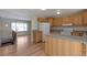 Kitchen with wood cabinets, granite counters, and island at 8714 W Burgundy Dr, Littleton, CO 80123