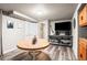 Finished basement area featuring a dining table and entertainment center with TV and shelving at 943 S Fairplay St, Aurora, CO 80012