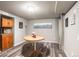 Finished basement space with vinyl floors, kitchenette, table, and decorative wall art at 943 S Fairplay St, Aurora, CO 80012
