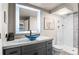 Contemporary bathroom with backlit mirror, unique vessel sink, marble countertops, and tiled walk-in shower at 943 S Fairplay St, Aurora, CO 80012