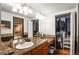 Primary bathroom showcasing a dual sink vanity, granite counters and spacious closet at 943 S Fairplay St, Aurora, CO 80012