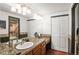 Bathroom vanity with granite countertop, double sinks, and tiled shower; bright lighting at 943 S Fairplay St, Aurora, CO 80012